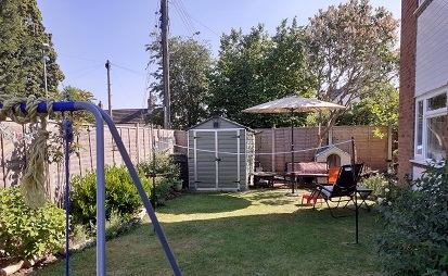 image od a typical garden, with shed, parasol, washing line and swing